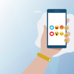 Image on standard seoplus+ blue triangle background, with illustration of a hand holding a mobile phone. The 6 Facebook reactions (like, love, angry, surprised, laughing, sad) are all featured on a white background on the phone screen.
